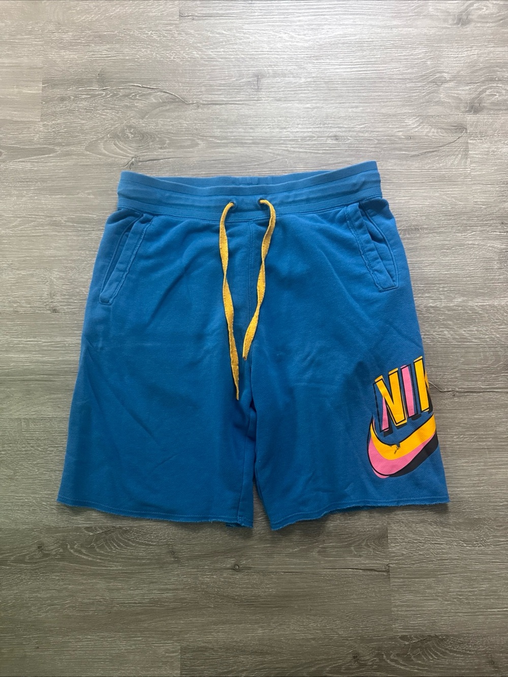 Nike Teal Athletic Shorts with Yellow Drawstring and Multicolor Logo